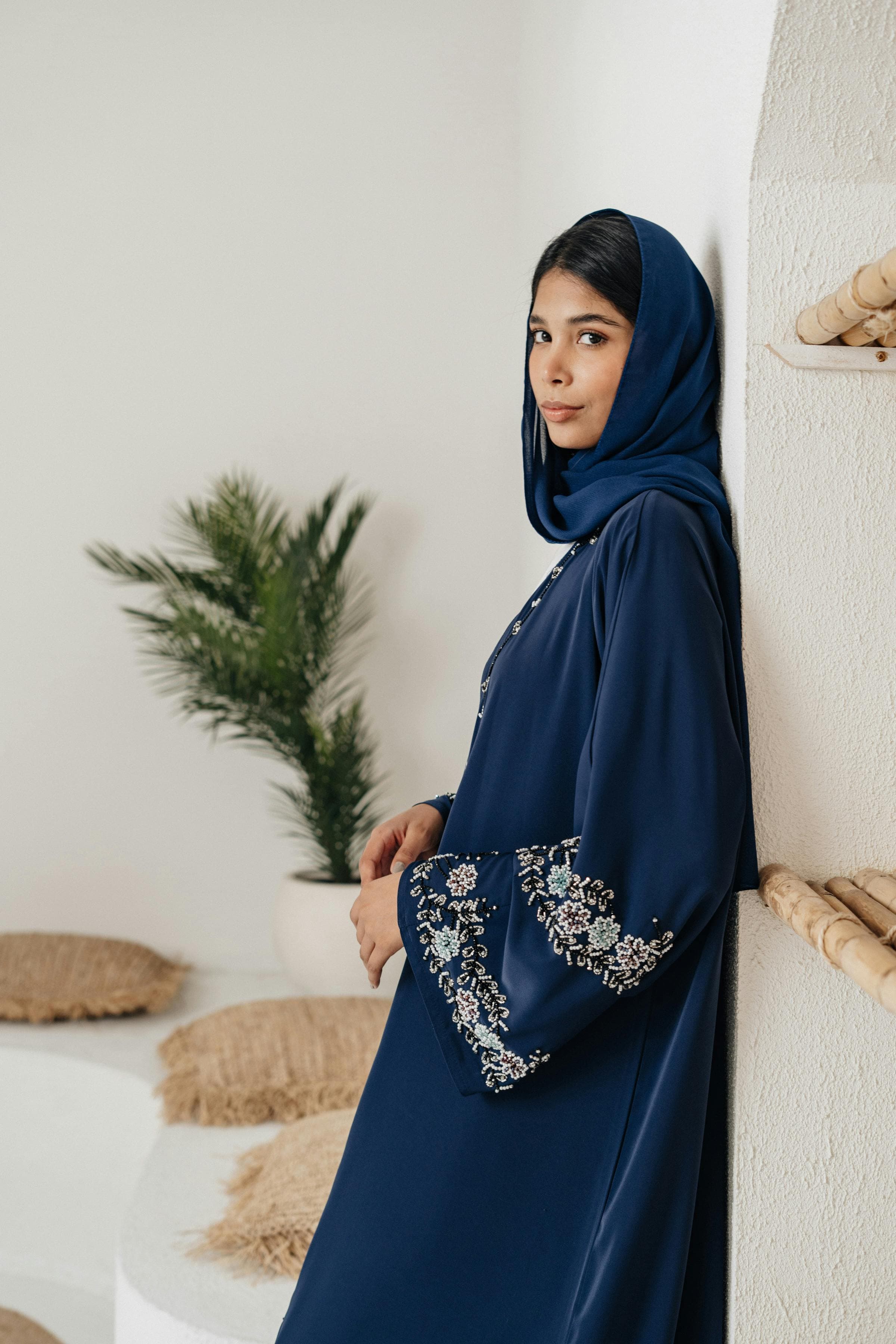 Woman wearing elegant navy blue embroidered abaya with hijab